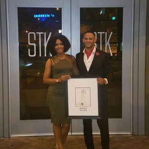 First year anniversary gift sketch with the couple holding it.